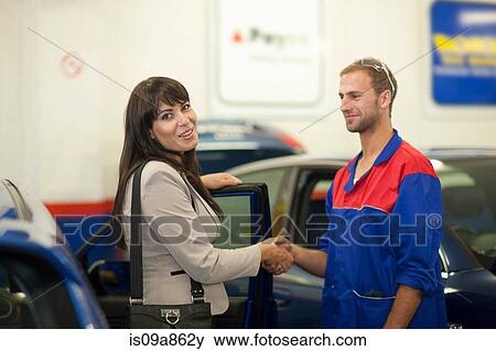 Woman thanking car mechanic View Large Photo Image Stock Photo - Woman thanking car mechanic. Fotosearch