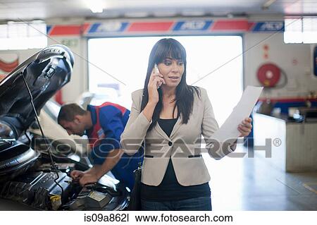Woman unhappy reading document relating to her car View Large Photo Image Stock Image - Woman unhappy reading document relating to her car. Fotosearch