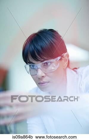Stock Image - Woman working in laboratory. Fotosearch