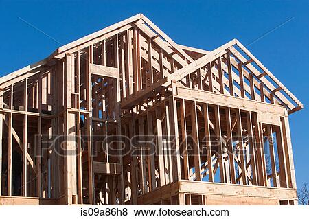 Wooden construction frame against blue sky View Large Photo Image Stock Photo - Wooden construction frame against blue sky. Fotosearch