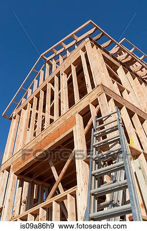 Wooden construction frame against blue sky View Large Photo Image Stock Photo - Wooden construction frame against blue sky. Fotosearch