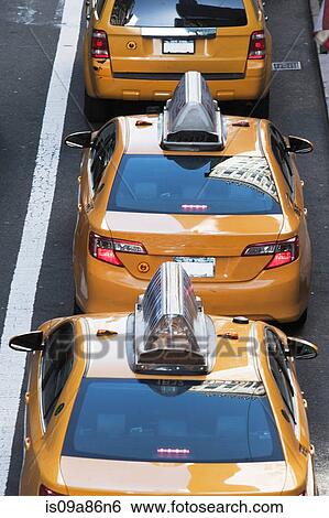 Stock Photograph - Yellow taxis in a row 42nd Street New York, USA. Fotosearch