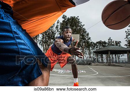 Young basketball players playing on court, close up View Large Photo Image Picture - Young basketball players playing on court, close up. Fotosearch