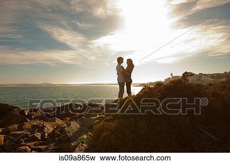 Young couple hugging on coastline View Large Photo Image Stock Photo - Young couple hugging on coastline. Fotosearch