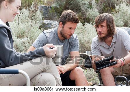 Young hikers taking a break View Large Photo Image Stock Photography - Young hikers taking a break. Fotosearch