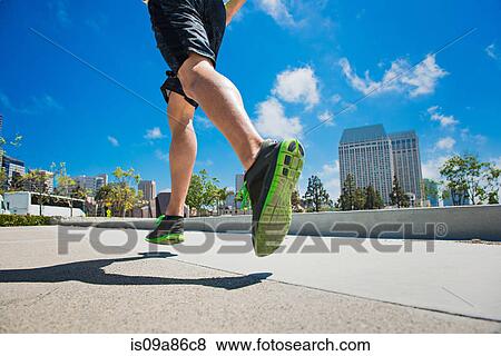 Young man jogging in city, low section View Large Photo Image Stock Photo - Young man jogging in city, low section. Fotosearch