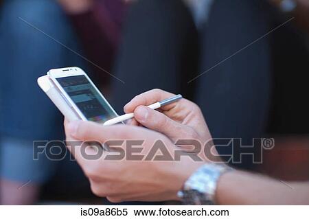 Young man using digital tablet View Large Photo Image Stock Photography - Young man using digital tablet. Fotosearch