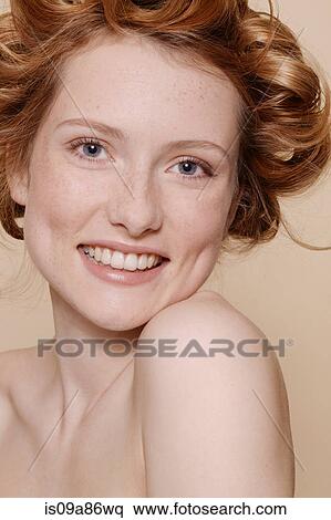 Stock Photography - Young woman with curly red hair, portrait. Fotosearch