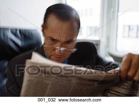 Stock Image - Businessman reading. Fotosearch