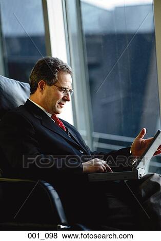 Businessman with laptop View Large Photo Image Stock Photo - Businessman with laptop. Fotosearch