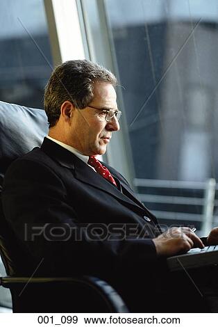 Businessman with laptop View Large Photo Image Stock Photo - Businessman with laptop. Fotosearch