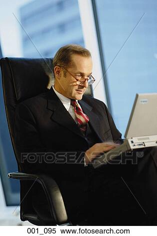 Businessman with laptop View Large Photo Image Stock Photography - Businessman with laptop. Fotosearch