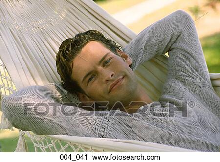 Stock Image - Man lying in hammock. Fotosearch
