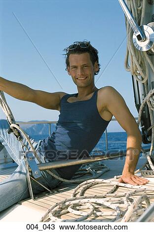 Man on sailing boat View Large Photo Image Stock Image - Man on sailing boat. Fotosearch