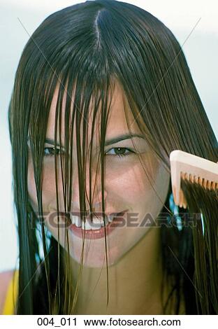 Woman combing her hair View Large Photo Image Stock Image - Woman combing her hair. Fotosearch