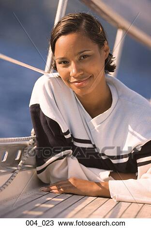 Stock Image - Woman on sailing boat. Fotosearch
