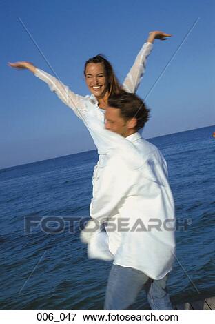 Couple at the seaside View Large Photo Image Stock Photo - Couple at the seaside. Fotosearch