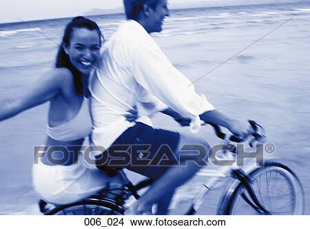 Picture - Couple on bicycle. Fotosearch