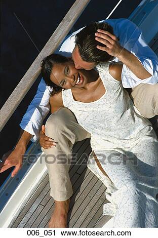 Stock Image - Couple on sailing boat. Fotosearch