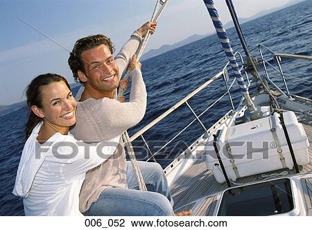 Stock Image - Couple on sailing boat. Fotosearch