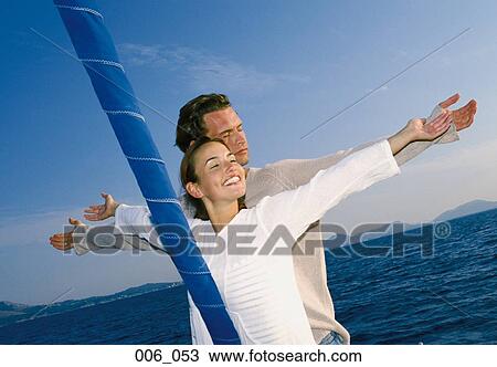 Stock Image - Couple on sailing boat. Fotosearch