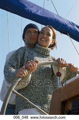 Stock Photo - Couple on sailing boat. Fotosearch