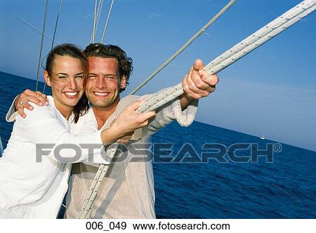 Stock Photo - Couple on sailing boat. Fotosearch
