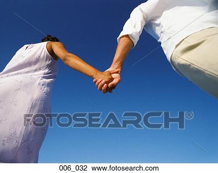 Stock Image - Holding hands. Fotosearch