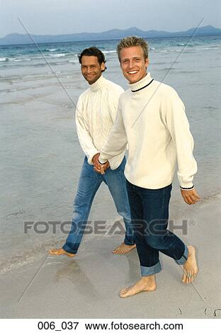 Men walking on the beach View Large Photo Image Stock Photo - Men walking on the beach. Fotosearch