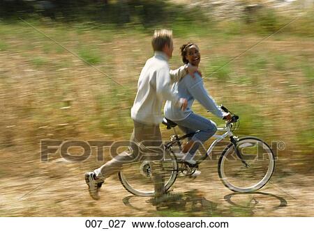 Couple cycling View Large Photo Image Stock Photo - Couple cycling. Fotosearch
