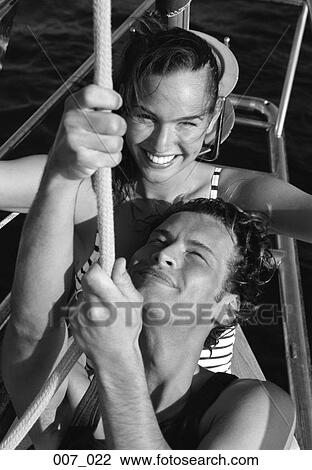 Stock Image - Couple on sailing boat. Fotosearch