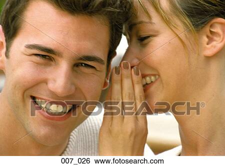 Stock Photograph - Couple whispering. Fotosearch