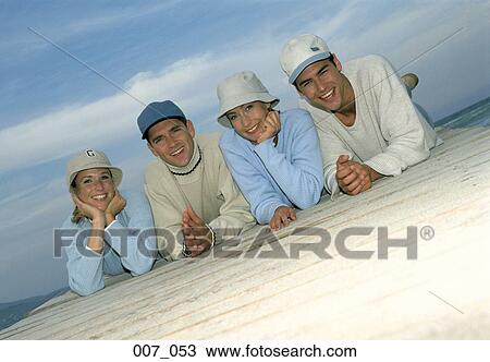Friends lying on pier View Large Photo Image Stock Image - Friends lying on pier. Fotosearch