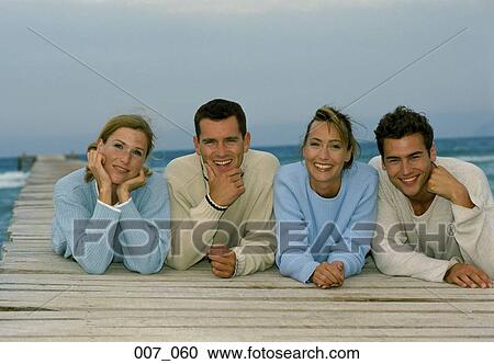Friends lying on pier View Large Photo Image Stock Image - Friends lying on pier. Fotosearch