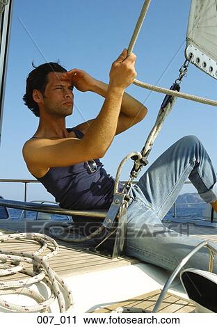Man on sailing boat View Large Photo Image Stock Image - Man on sailing boat. Fotosearch