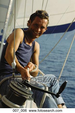 Man on sailing boat View Large Photo Image Stock Photograph - Man on sailing boat. Fotosearch
