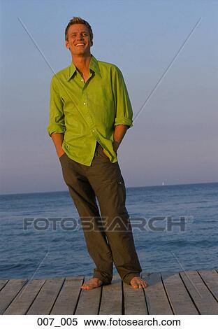Man standing on pier View Large Photo Image Stock Photography - Man standing on pier. Fotosearch