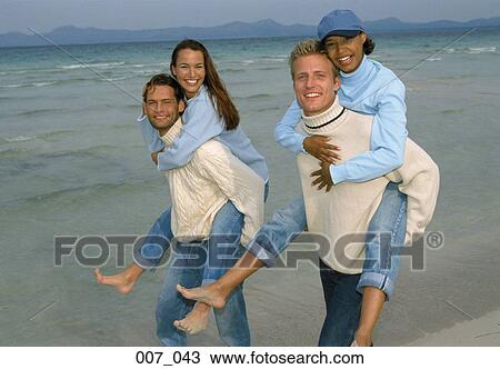Stock Image - Two couples on the beach. Fotosearch