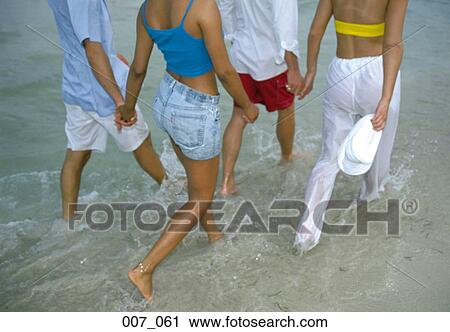 Two couples on the beach View Large Photo Image Stock Image - Two couples on the beach. Fotosearch