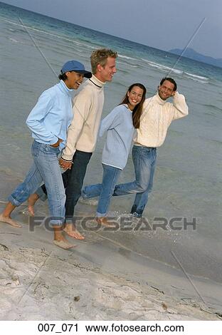 Stock Image - Two couples on the beach. Fotosearch