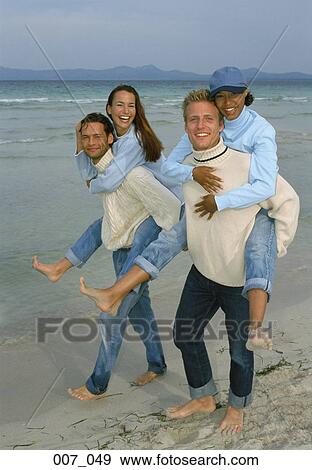 Stock Photo - Two couples on the beach. Fotosearch