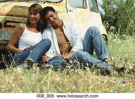 Couple leaning against car View Large Photo Image Stock Photography - Couple leaning against car. Fotosearch
