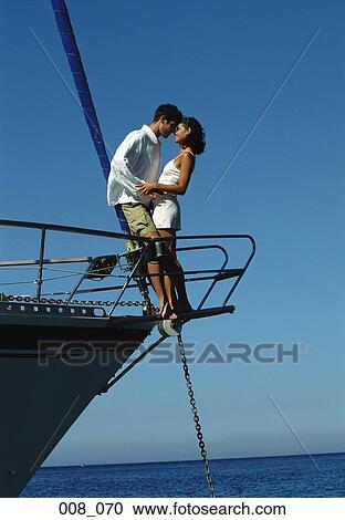 Stock Image - Couple on sailing boat. Fotosearch