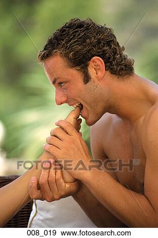 Playful toe-biting View Large Photo Image Stock Photo - Playful toe-biting. Fotosearch