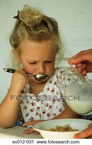 Stock Image - Girl eating cornflakes. Fotosearch