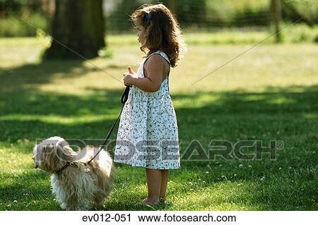 Stock Image - Girl walking dog. Fotosearch