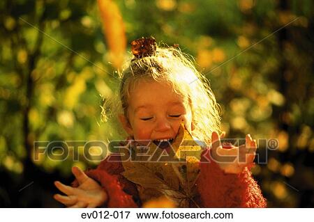Stock Photo - Girl with autumn leaves. Fotosearch
