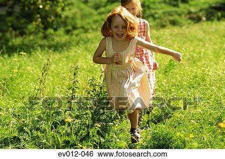 Stock Photograph - Girls in field. Fotosearch
