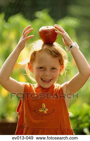 Stock Photo - Girl with apple. Fotosearch