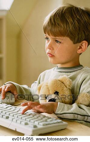 Stock Photography - Boy at computer. Fotosearch